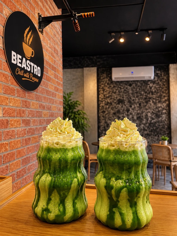 Two blended matcha drinks topped with whipped cream