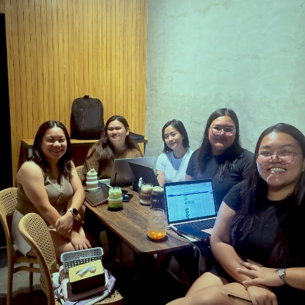 Friends working on laptops over iced drinks