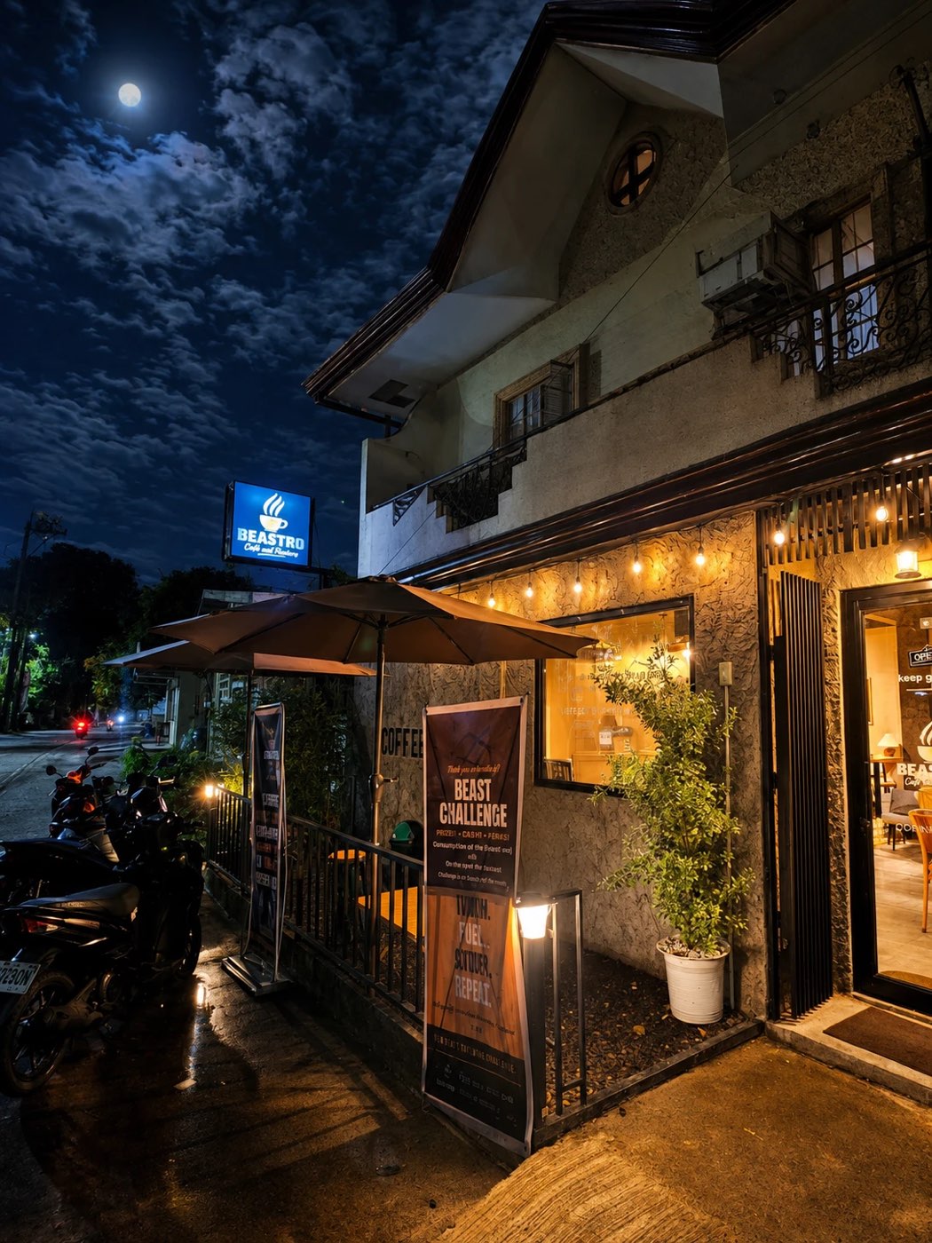 The Beastro entrance at night with the lit sign and an open door