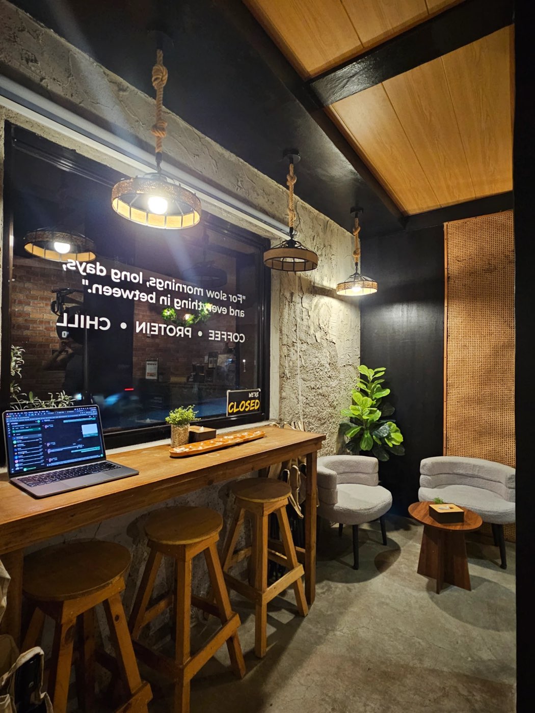Window bar with wooden stools and the Coffee, Protein, Chill decal